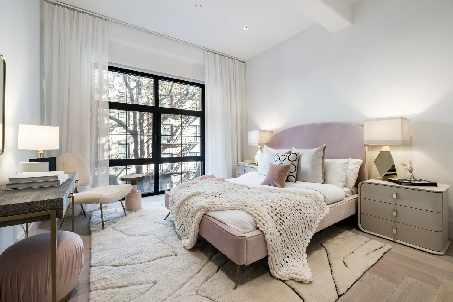 a bedroom with a bed and a large window