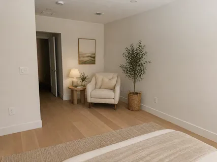 a living room with furniture and a potted plant