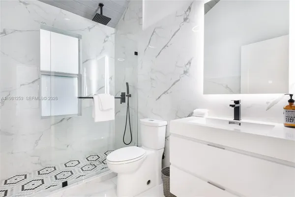 a bathroom with a sink toilet and shower