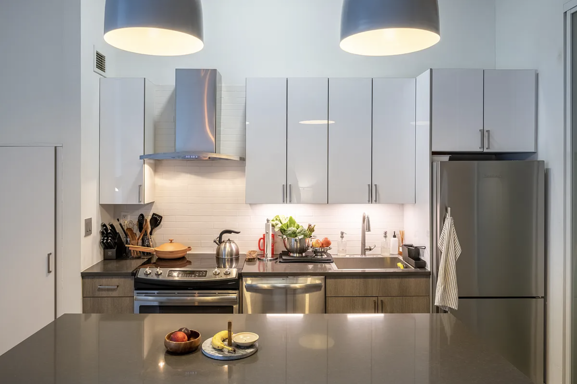 44 Berry Street, Unit 5E Brooklyn, NY 11249 - Photo 3 of 9 a kitchen with stainless steel appliances granite countertop a refrigerator and a stove