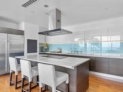 a kitchen with stainless steel appliances granite countertop a sink a stove and a refrigerator