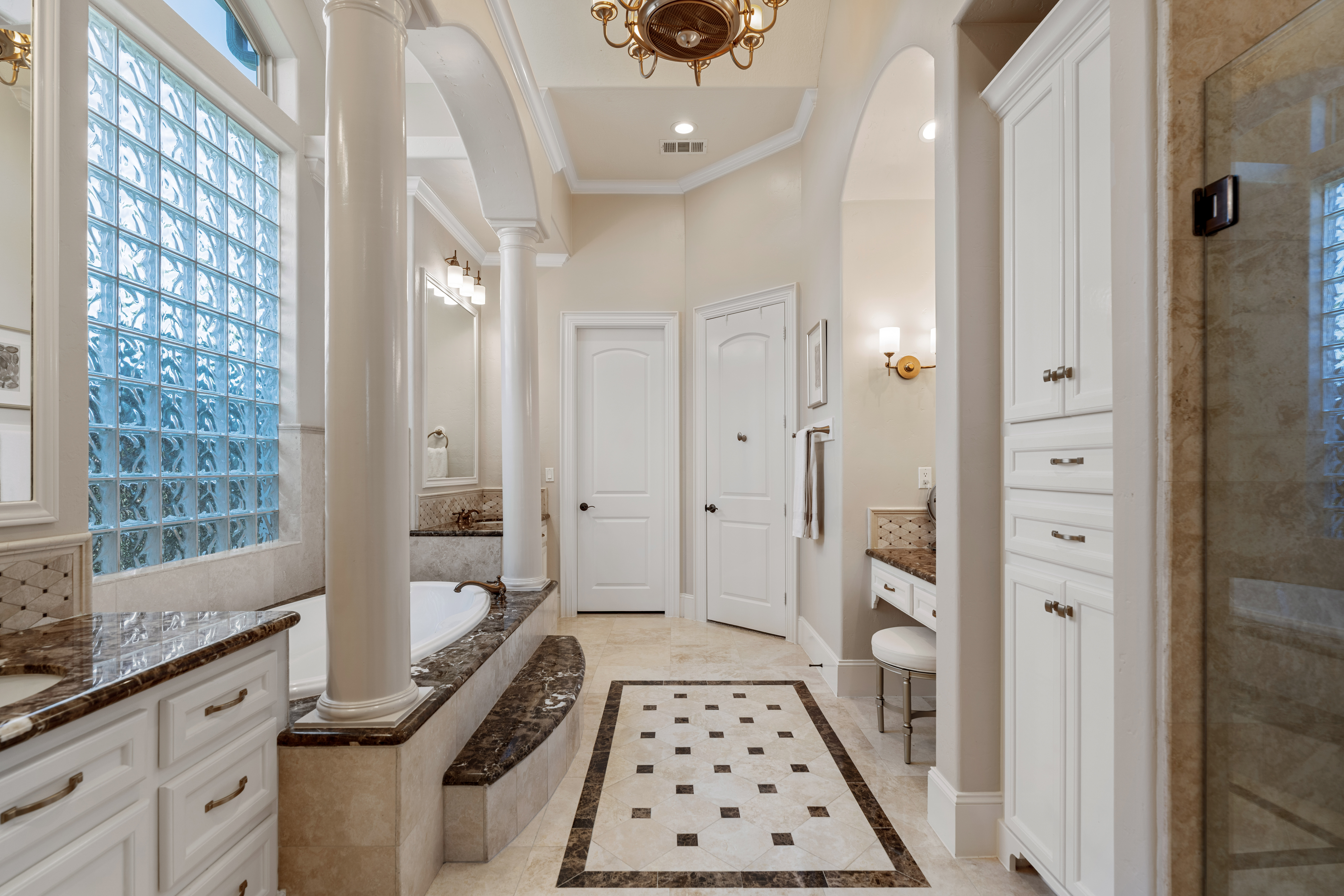 82 Manor Lake Estates Circle Spring, TX 77379 - Photo 26 of 52 a bathroom with a double vanity sink a toilet a glass door shower and a mirror