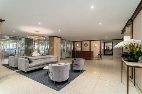 a living room with furniture and large windows