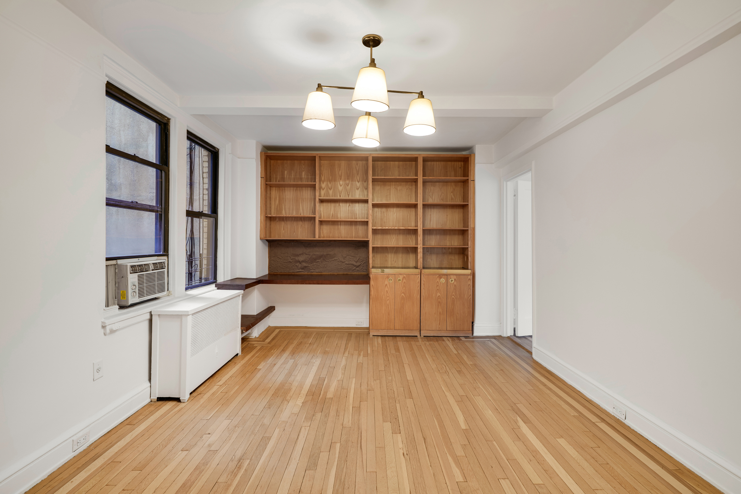 74 West 68th Street, Unit 5A Manhattan, NY 10023 - Photo 15 of 25 wooden floor in an empty room with a window