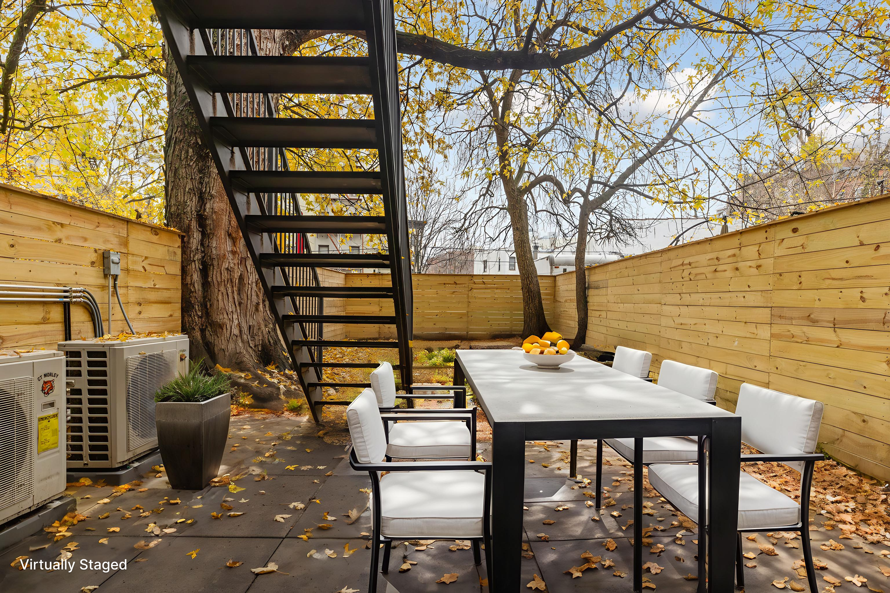 15 Verona Place, Unit GARDEN Brooklyn, NY 11216 - Photo 11 of 14 a view of a patio with table and chairs and potted plants