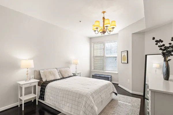 a bedroom with a bed and a chandelier