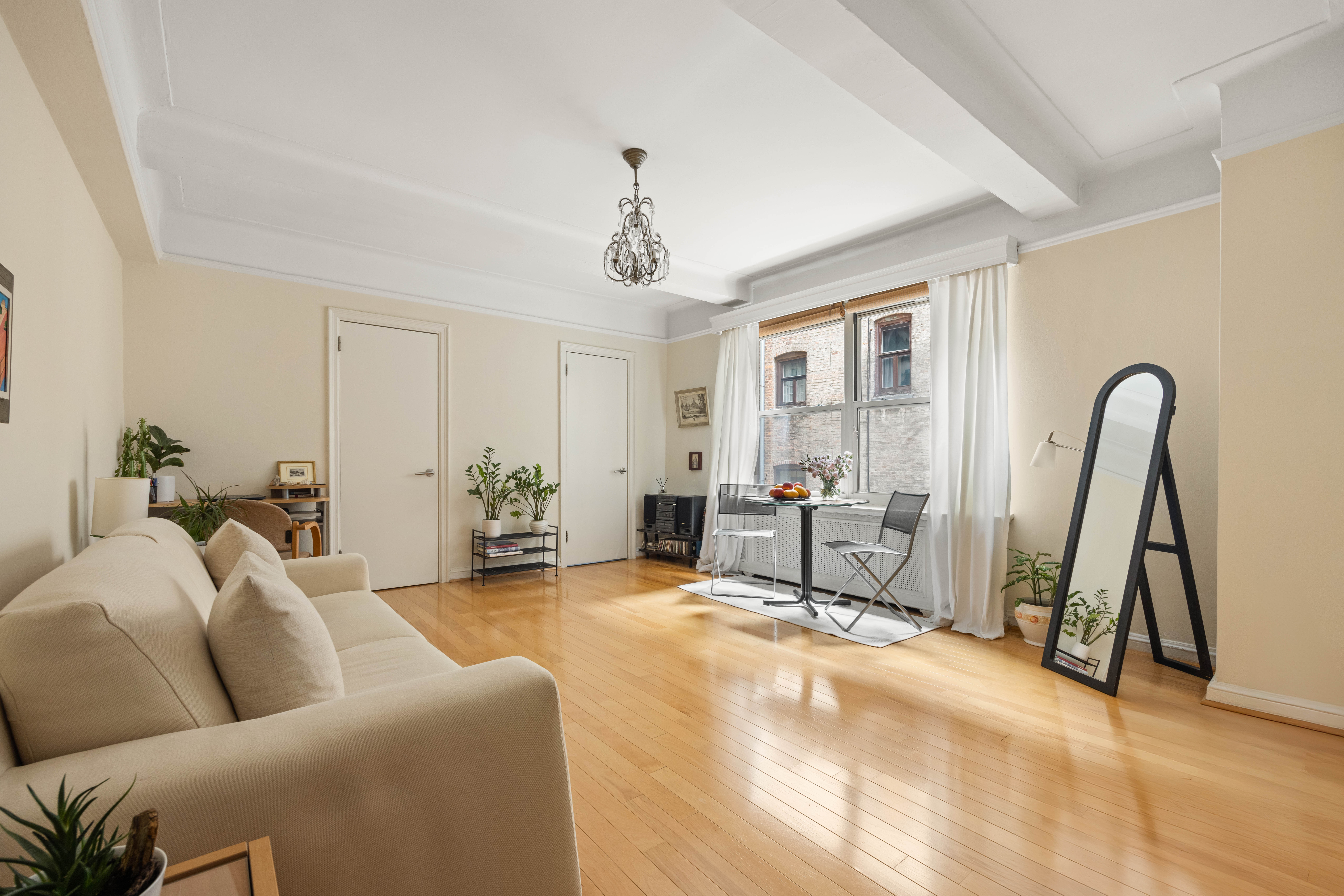 a living room with furniture a flat screen tv and a large window