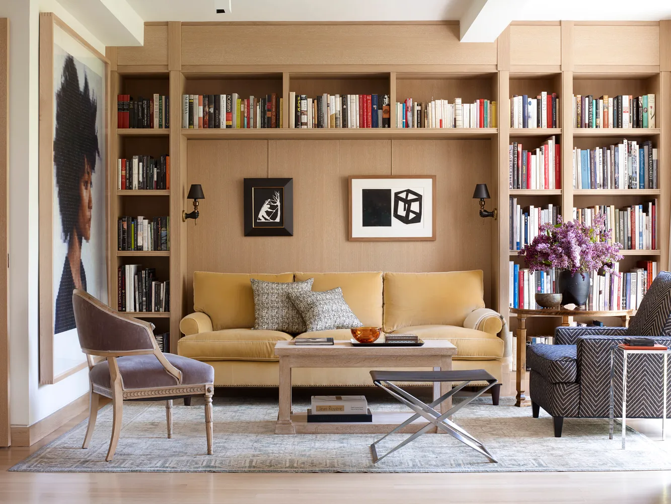 a living room with furniture and a book shelf