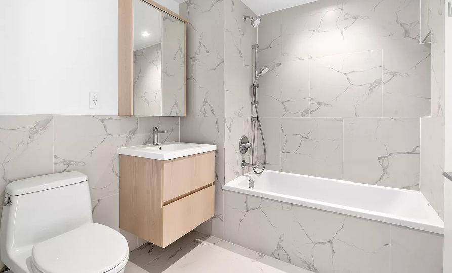 567 Ocean Avenue, Unit A607 Brooklyn, NY 11226 - Photo 4 of 12 a bathroom with a sink toilet and bathtub