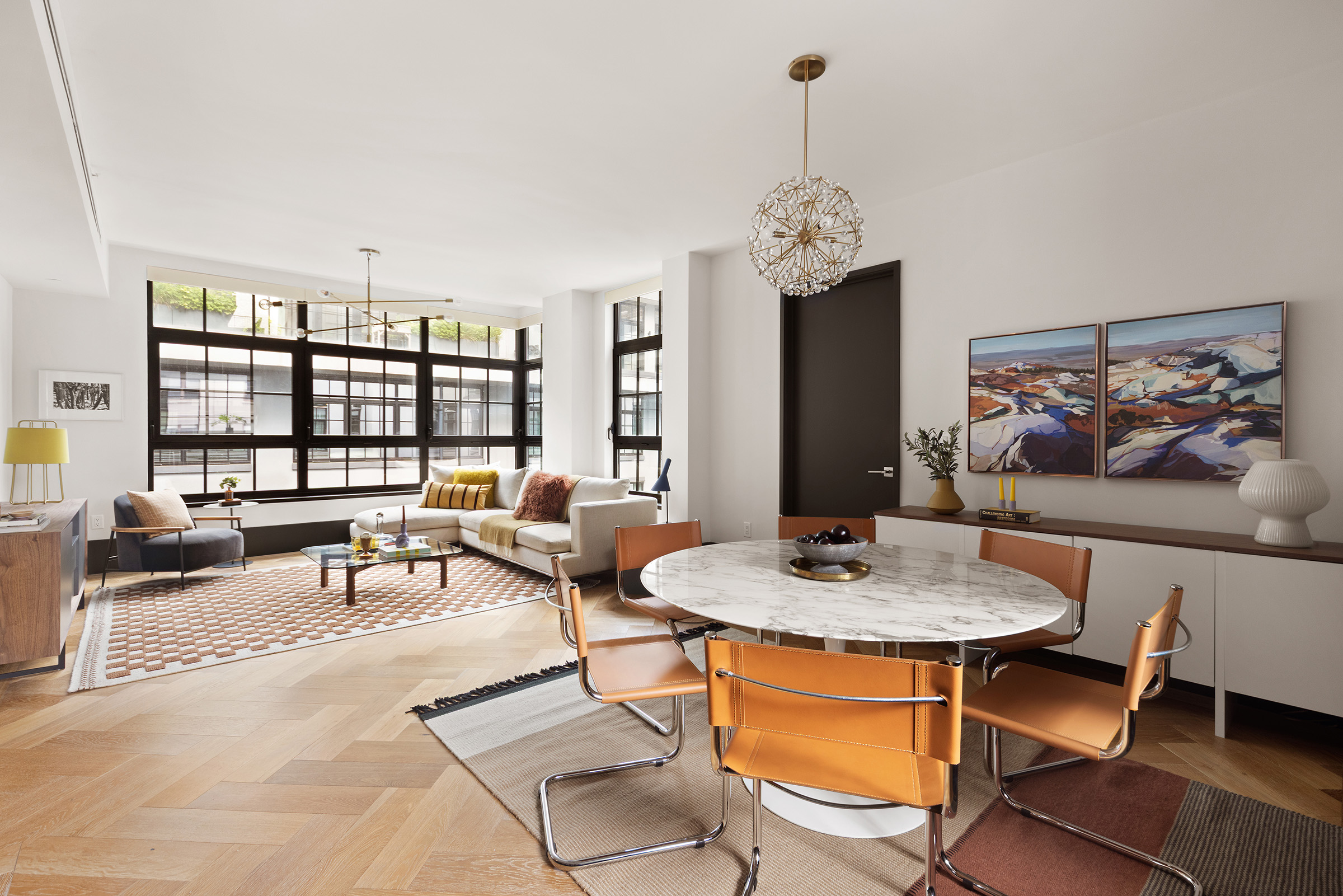 51 Jay Street, Unit 5J Brooklyn, NY 11201 - Photo 4 of 23 a living room with furniture a rug and a chandelier