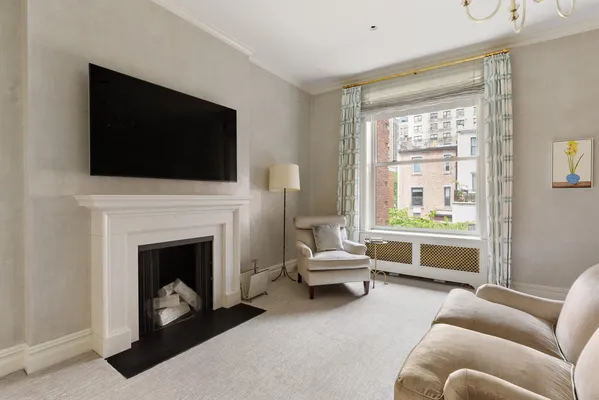 a living room with furniture a flat screen tv and a fireplace