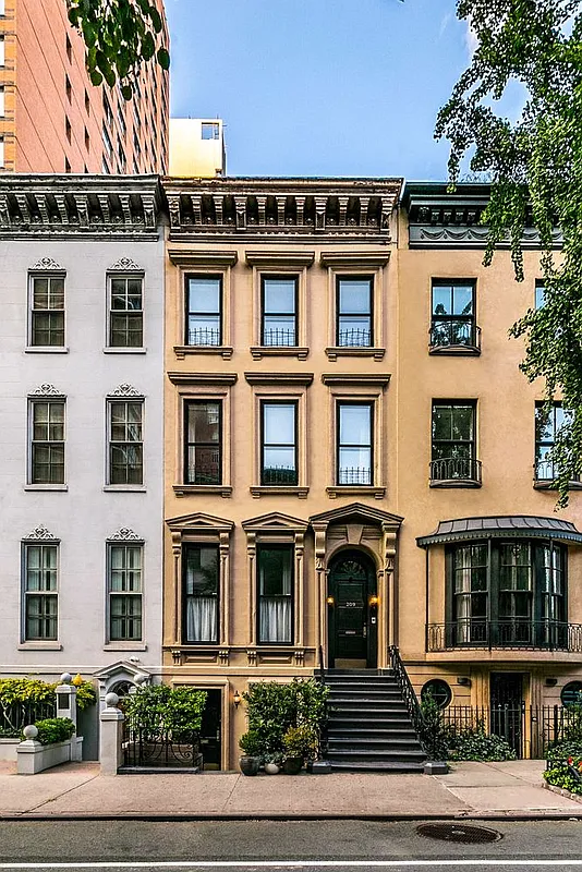 209 East 61st Street Manhattan, NY 10065 - Photo 24 of 27 a front view of a residential apartment building with a yard
