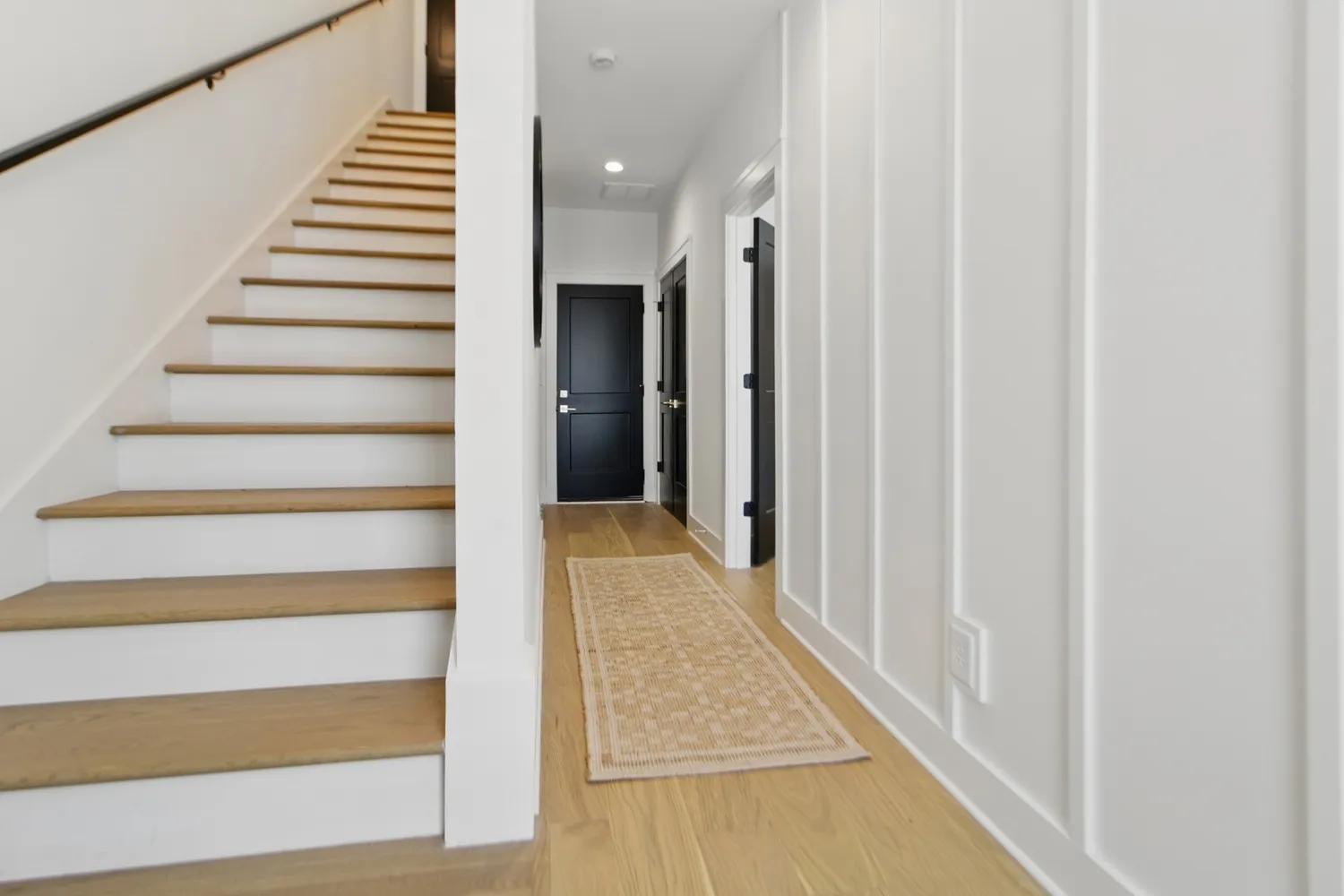 a view of entryway with wooden floor and stairs