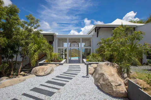 a view of a house with backyard and sitting area