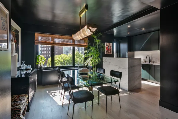 a living room with furniture a fireplace and a dining table with wooden floor