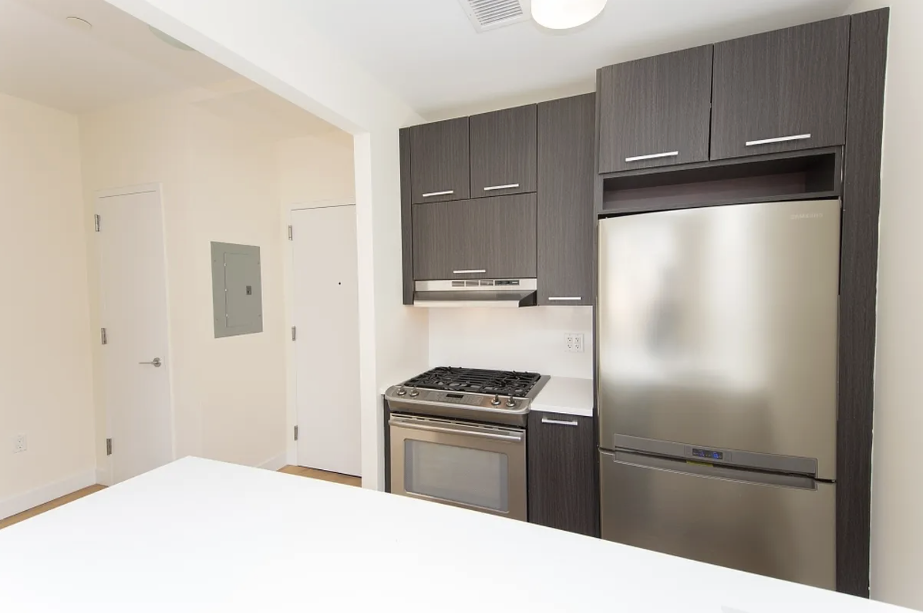65 North 6th Street, Unit 5B Brooklyn, NY 11249 - Photo 2 of 5 a kitchen with a refrigerator and a stove top oven