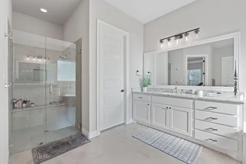 a bathroom with a granite countertop sink mirror and double