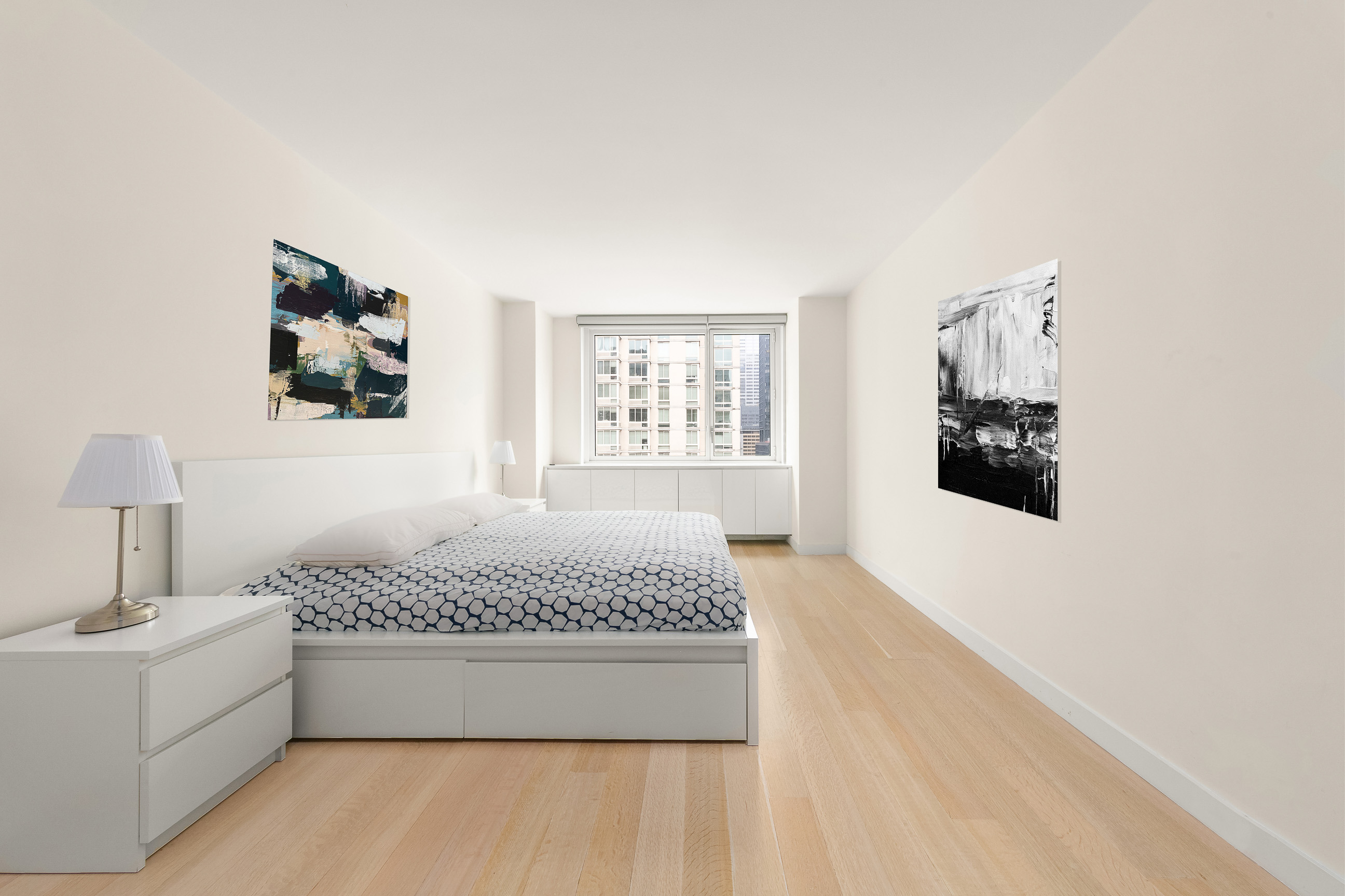 301 West 53rd Street, Unit 19K Manhattan, NY 10019 - Photo 4 of 8 a spacious bedroom with a large bed and a window