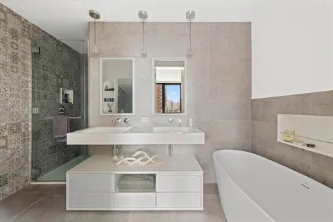 a bathroom with a sink a mirror and a bathtub