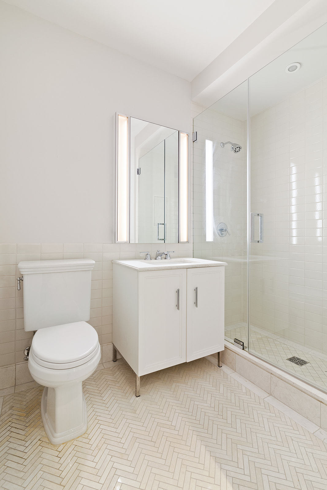 100 Barclay Street, Unit 13K Manhattan, NY 10007 - Photo 10 of 11 a bathroom with a toilet sink and mirror
