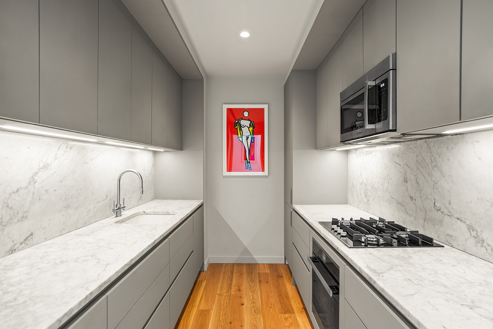 547 West 47th Street, Unit 1102 Manhattan, NY 10036 - Photo 5 of 19 a kitchen with a stove and a sink