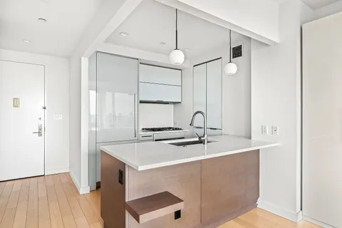 a kitchen with stainless steel appliances granite countertop a sink and a refrigerator