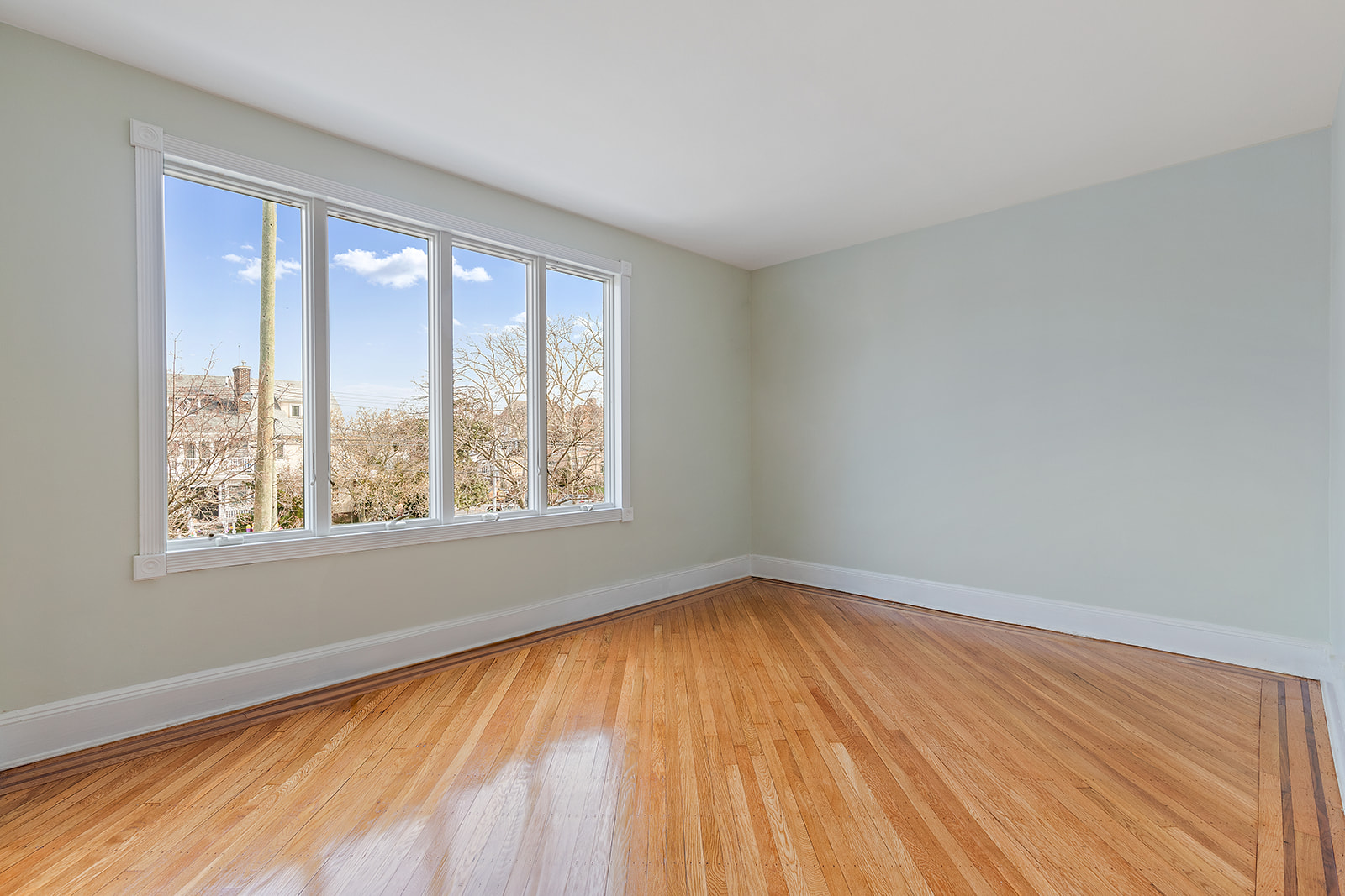 96 86th Street Brooklyn, NY 11209 - Photo 9 of 13 a view of an empty room with wooden floor and a window