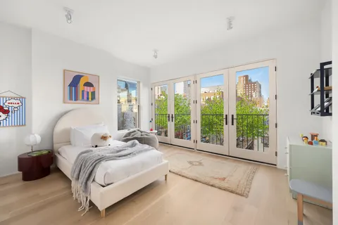 a spacious bedroom with a bed and a large window