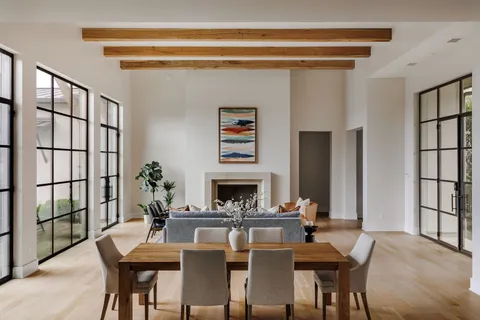 a dining room with furniture window and wooden floor