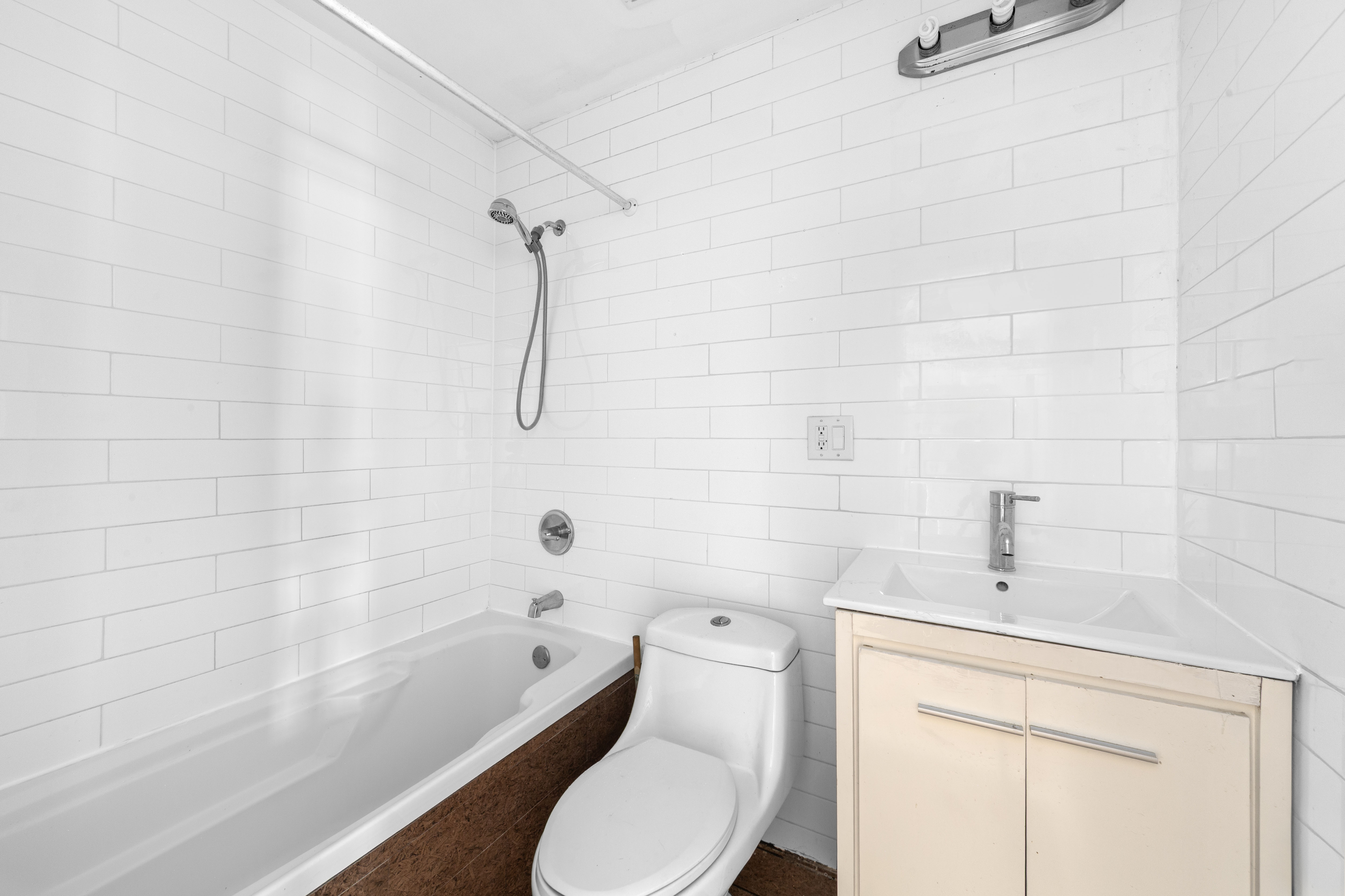 2311 Cortelyou Road Brooklyn, NY 11226 - Photo 3 of 10 a bathroom with a toilet and a shower