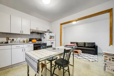 a kitchen with a table and chairs in it