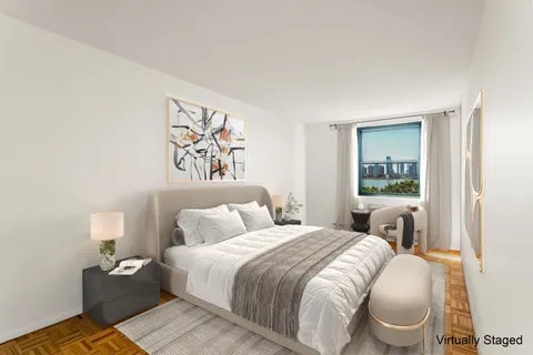 a bedroom with a bed and a painting on the wall