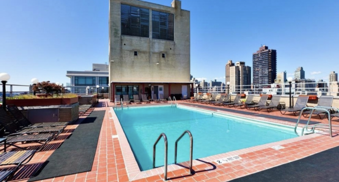 180 East End Avenue, Unit 15E Manhattan, NY 10128 - Photo 28 of 31 a swimming pool with outdoor seating and yard