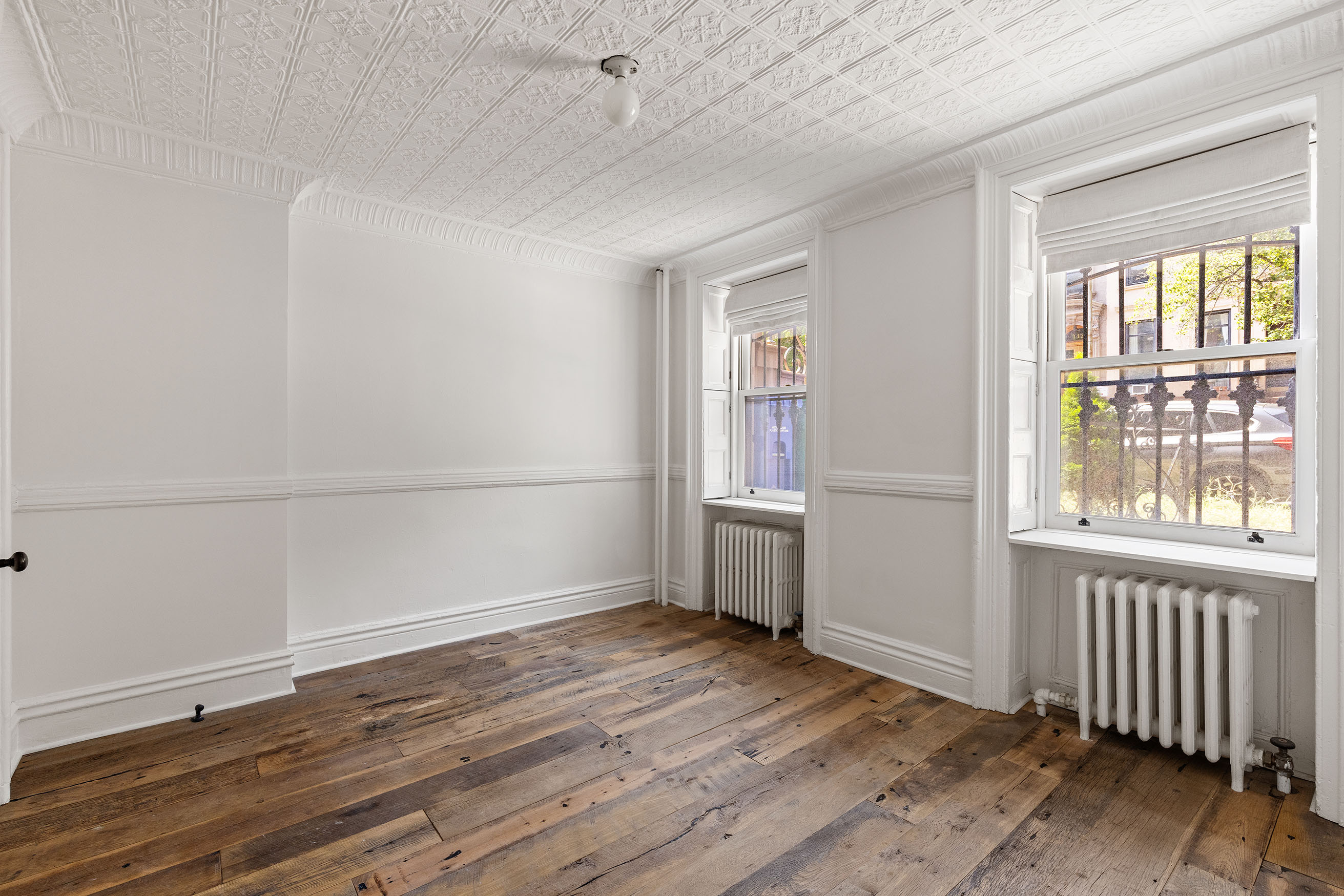 121 St James Place, Unit GARDEN Brooklyn, NY 11238 - Photo 4 of 8 an empty room with wooden floor and windows