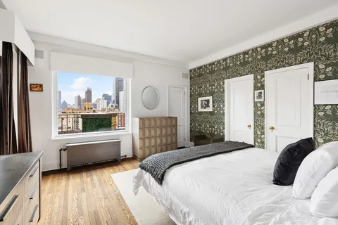 a bedroom with a large bed and a large window