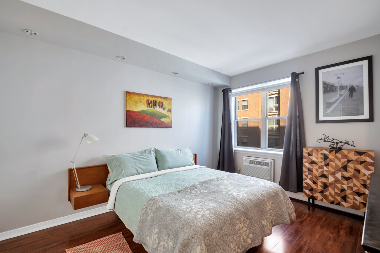 1787 Madison Avenue, Unit 312 Manhattan, NY 10035 - Photo 4 of 8 a bedroom with a bed and wooden floor