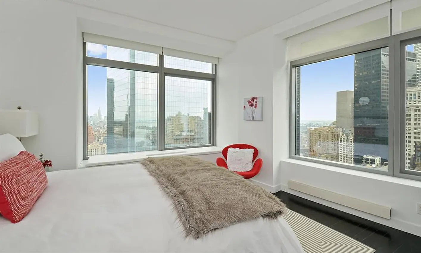 a bed sitting in front of a window