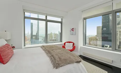 a bed sitting in front of a window