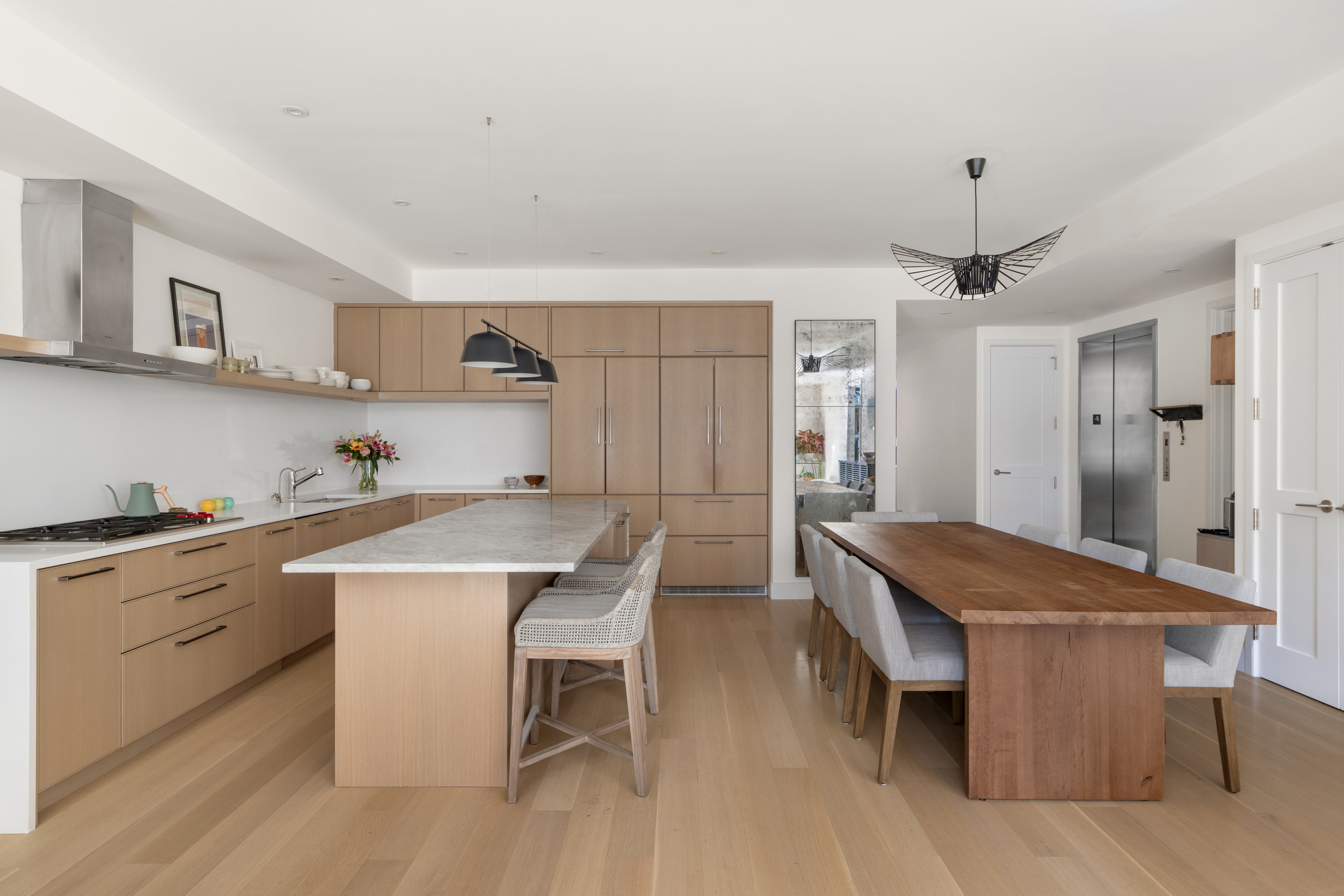 134 West 83rd Street, Unit 4 Manhattan, NY 10024 - Photo 6 of 17 a kitchen with a table chairs a sink dishwasher and cabinets