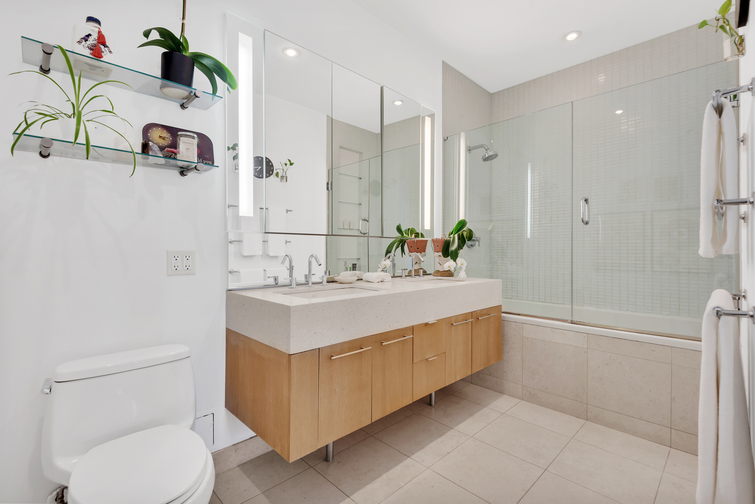 85 Adams Street, Unit 15D Brooklyn, NY 11201 - Photo 7 of 8 a bathroom with a sink a toilet and shower