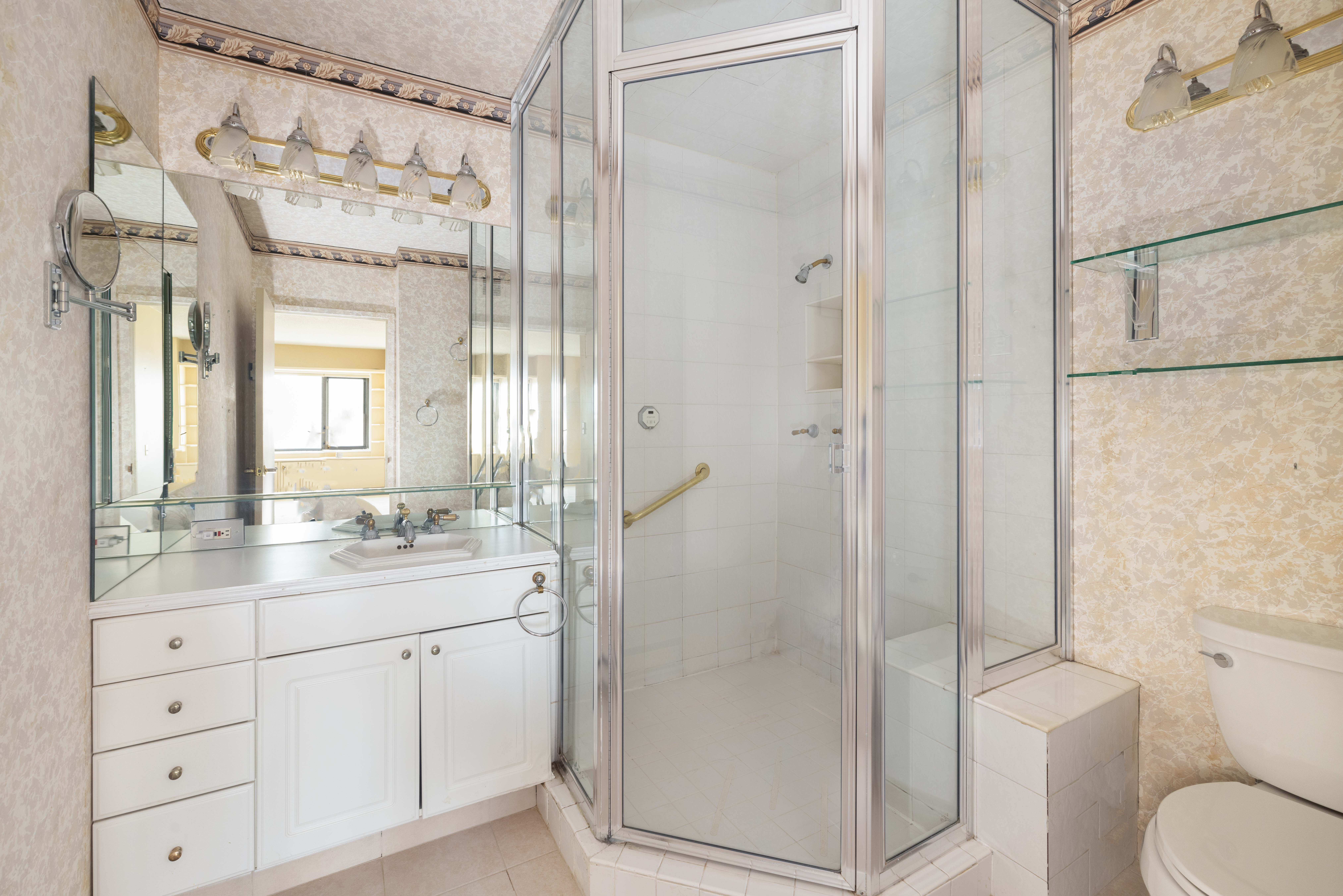 20 West 64th Street, Unit 41H Manhattan, NY 10023 - Photo 13 of 39 a bathroom with a granite countertop sink toilet and shower