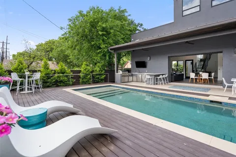 a view of house with backyard and outdoor seating