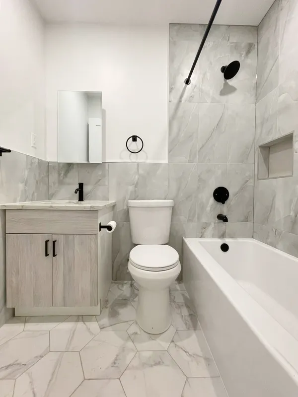 a bathroom with a toilet sink and shower
