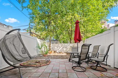a view of a chairs and table in backyard