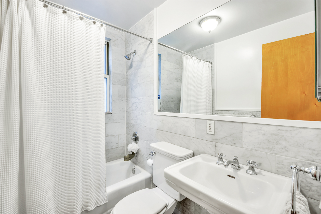 40 Dean Street, Unit 2B Brooklyn, NY 11201 - Photo 4 of 7 a bathroom with a sink toilet and shower
