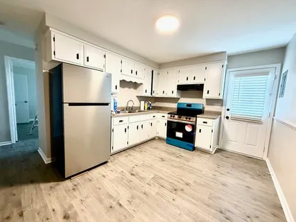 a kitchen with stainless steel appliances a refrigerator sink and cabinets