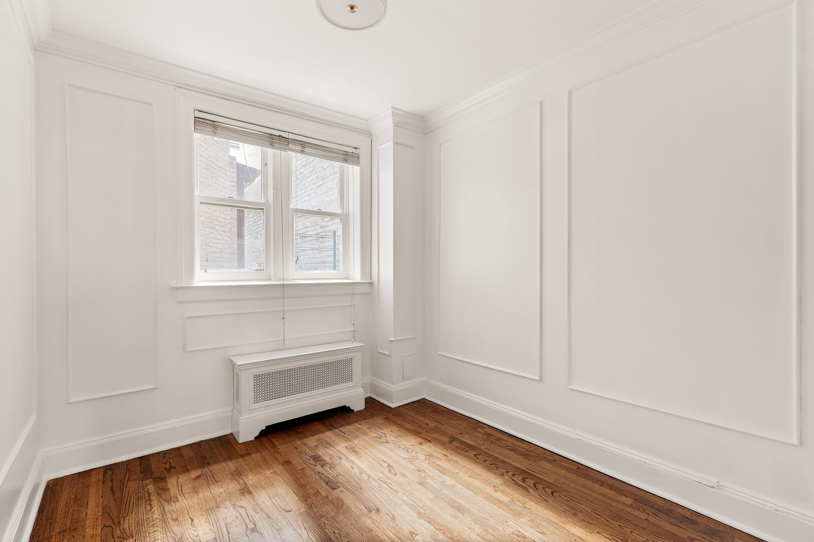 129 East 61st Street, Unit 3 Manhattan, NY 10065 - Photo 9 of 13 a view of room with hardwood floor and window