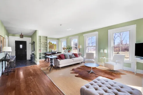 a picture of floor with a white wall and a painting