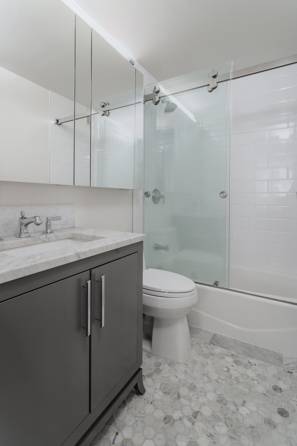 200 East 94th Street, Unit 2015 Manhattan, NY 10128 - Photo 9 of 16 a bathroom with a sink a toilet and shower