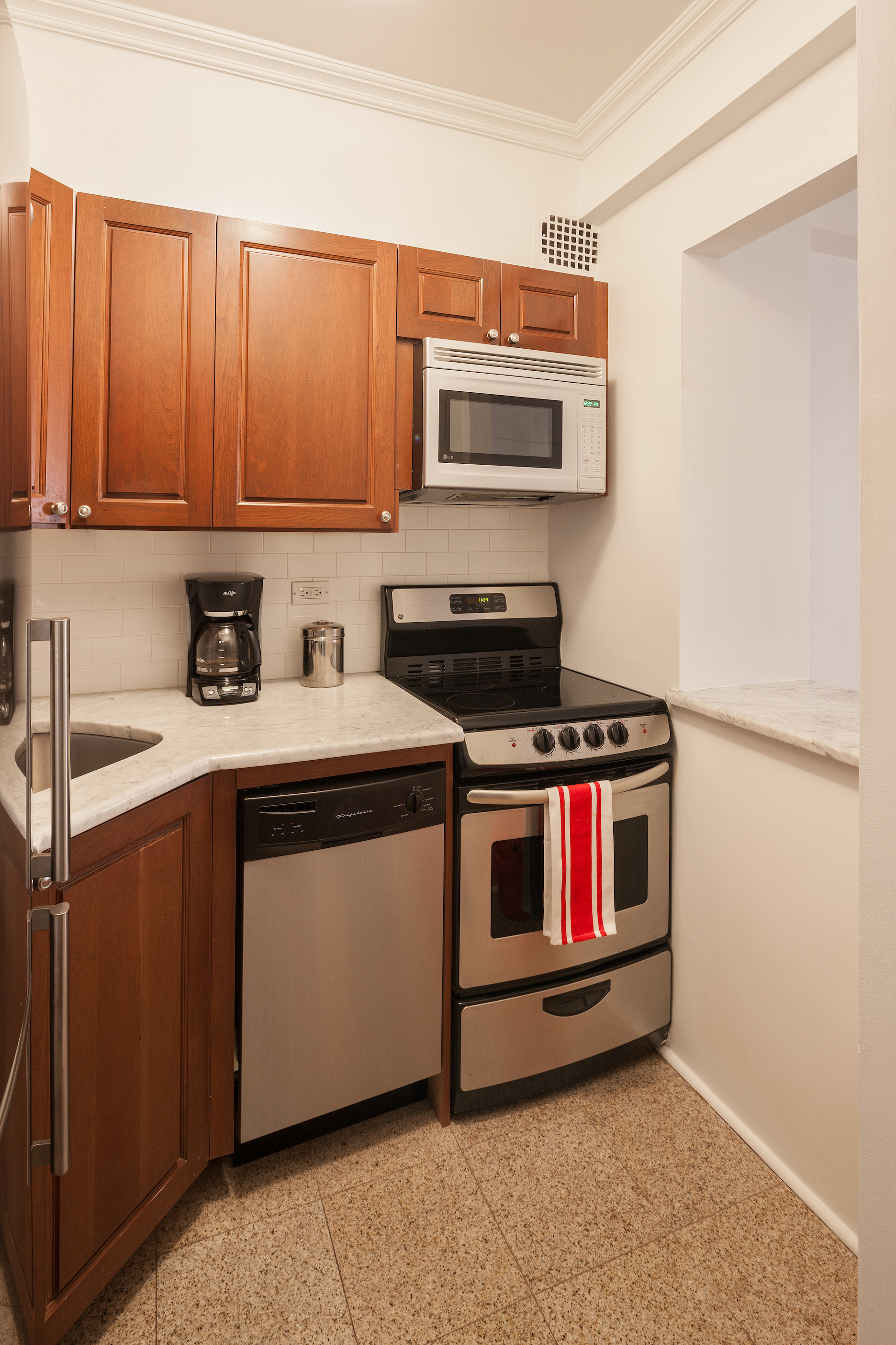 80 Park Avenue, Unit 8B Manhattan, NY 10016 - Photo 4 of 6 a kitchen with stainless steel appliances a stove a microwave and sink